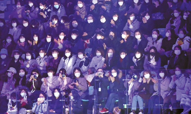 SEOUL: Spectators wear face masks to help prevent the spread of the coronavirus as they watch a skating gala on Sunday. South Korea has confirmed 27 cases of the virus so far.—AFP