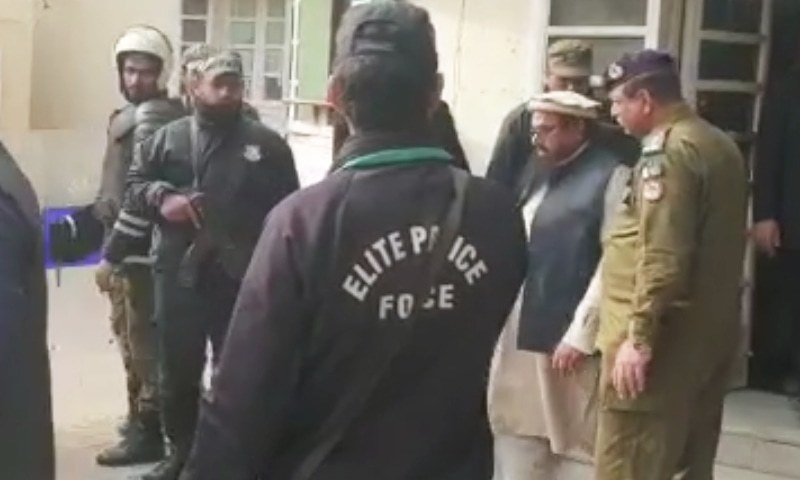 JuD chief Hafiz Saeed walks out of a Lahore ATC after being sentenced in two terror financing cases. — DawnNewsTV