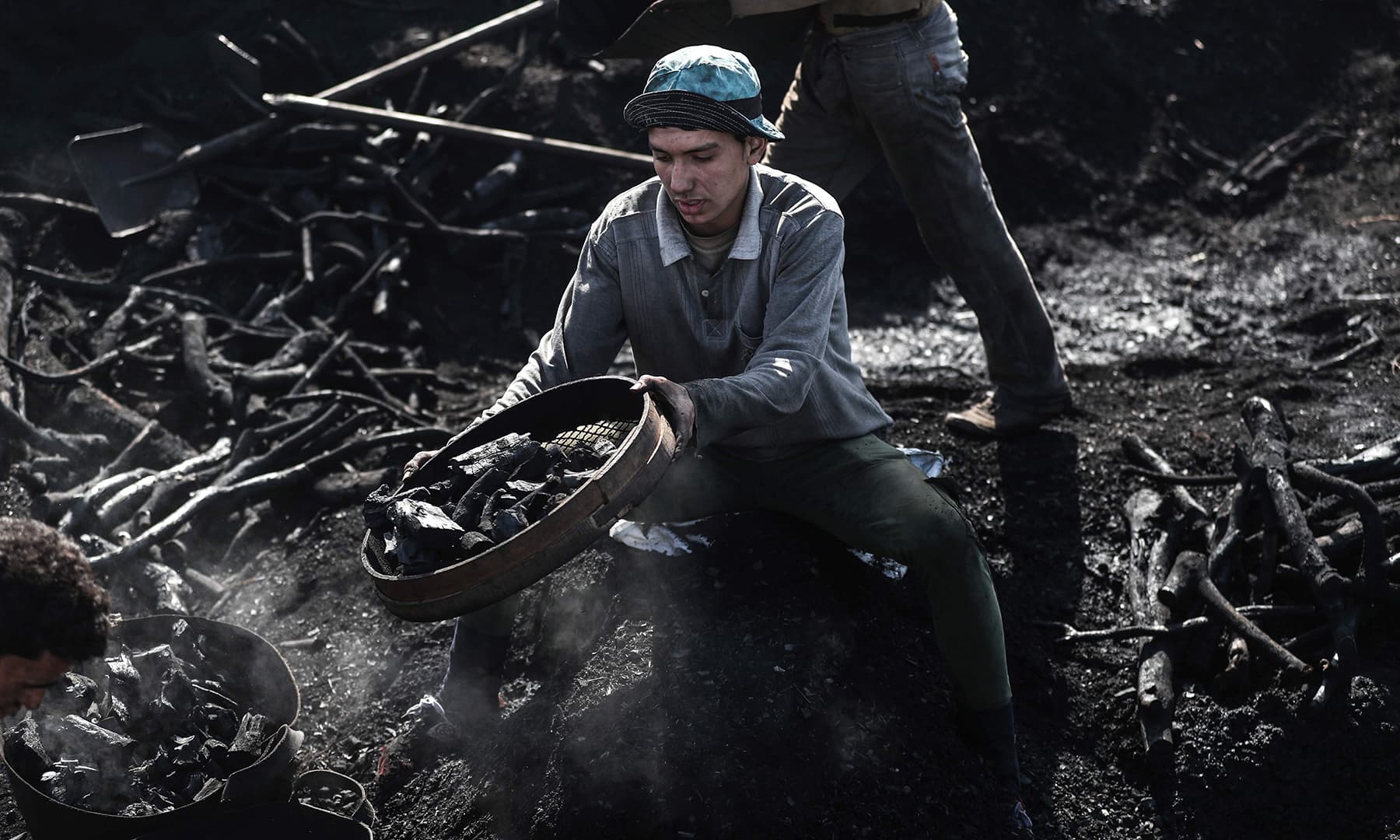 An Egyptian labourer works at a charcoal factory in Egypt's Sharkia governorate. — AFP