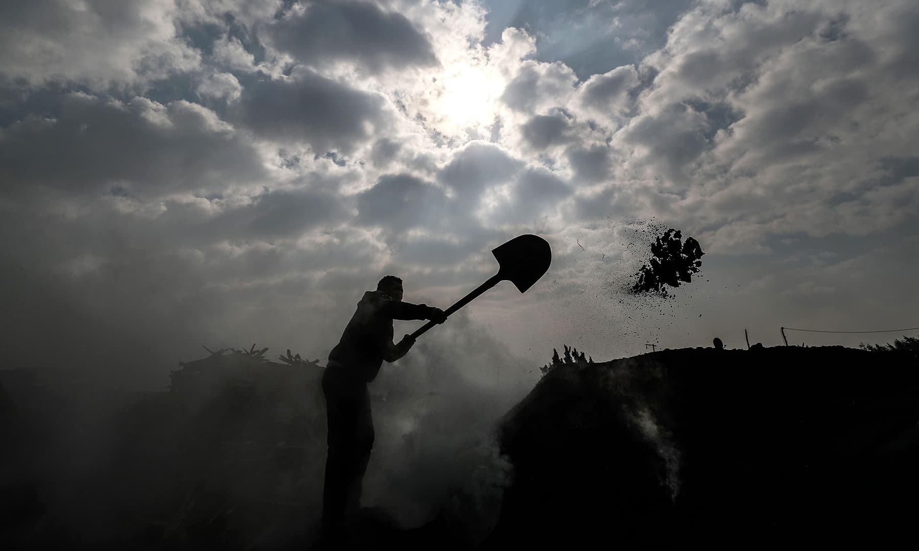 An Egyptian labourer works at a charcoal factory in Egypt's Sharkia governorate. — AFP