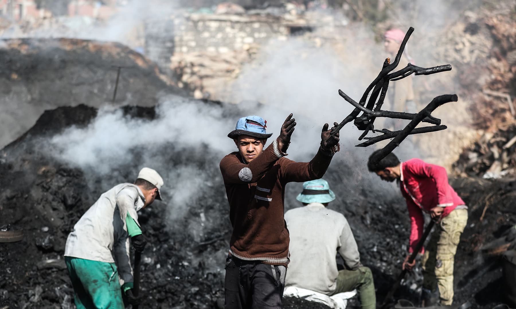 Egyptian labourers work at a charcoal factory in Egypt's Sharkia governorate. — AFP