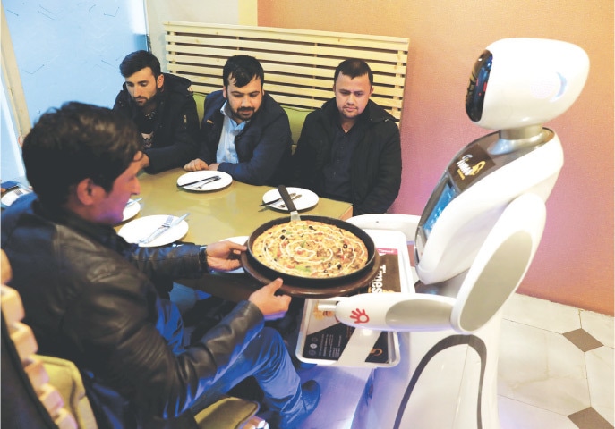 Kabul: The waitress robot delivers food to customers at the Times Fast Food restaurant.—Reuters