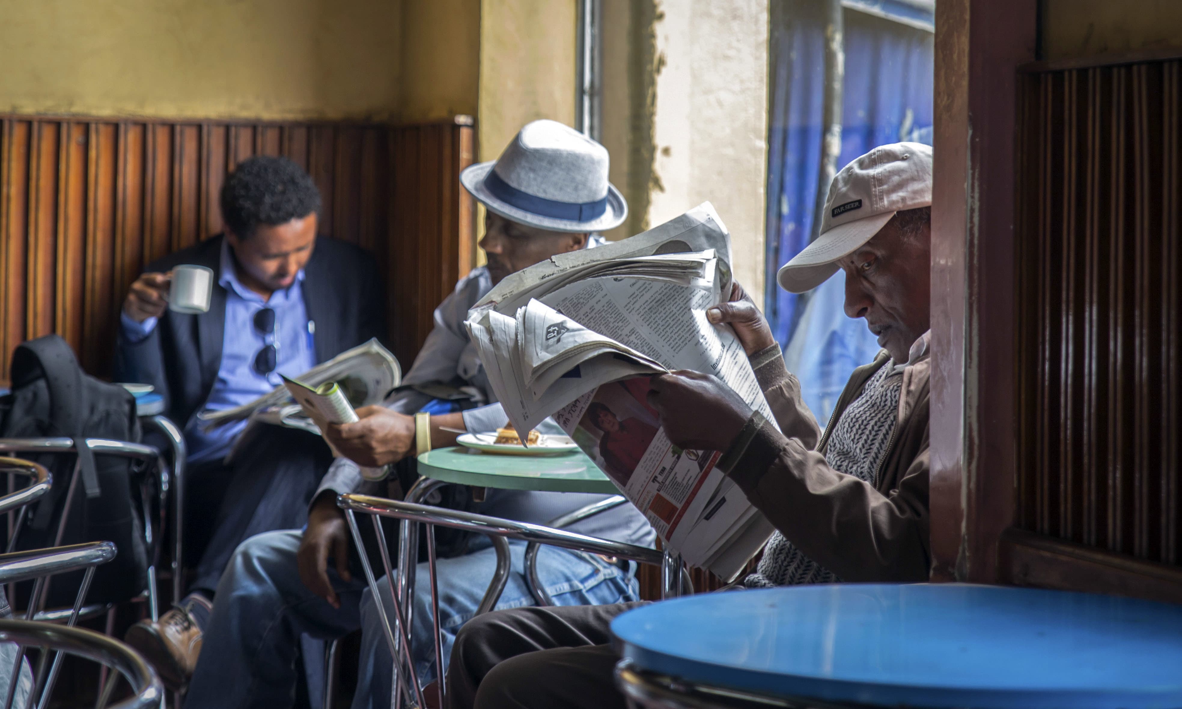 In this Monday, Oct. 10, 2016 file photo, Ethiopian men read newspapers and drink coffee at a cafe during a declared state of emergency and internet shutdown in Addis Ababa, Ethiopia. — AP