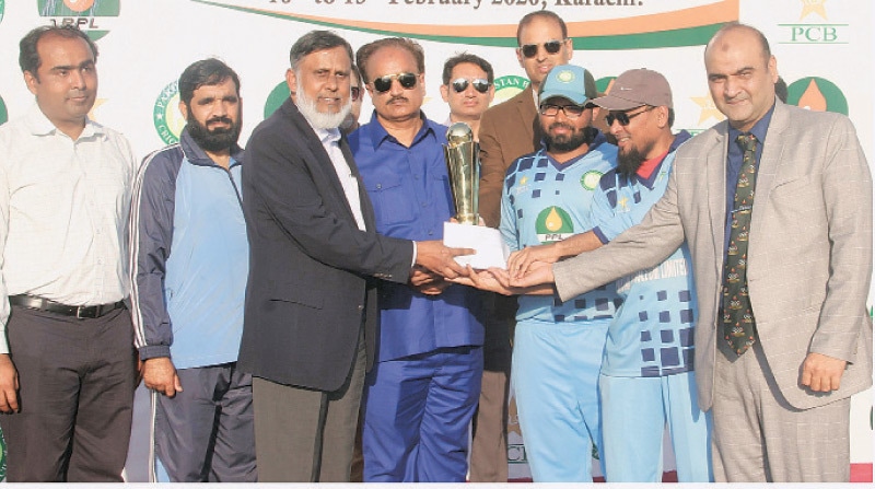 SINDH captain Nisar Ali receives the Blind Cricket Super League trophy from PPL Deputy MD Khalid Raza as PBCC chairman Syed Sultan Shah and Air Commodore Aftab Alam look on.