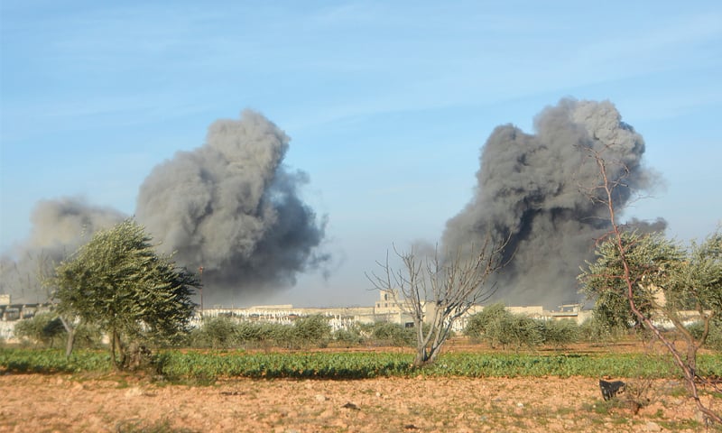 IDLIB: Smoke plumes rise following an air strike by pro-government forces on the western sector of this north-western Syrian city on Thursday.—AFP