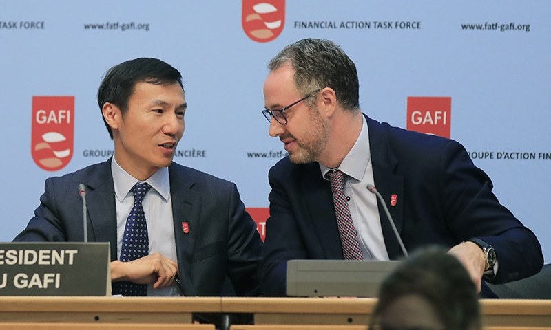 FATF President Xiangmin Liu, left, and Executive Secretary of the FATF David Lewis talk to each other after a media conference at the OECD headquarters in Paris, Friday, Oct. 18, 2019. — AP/File