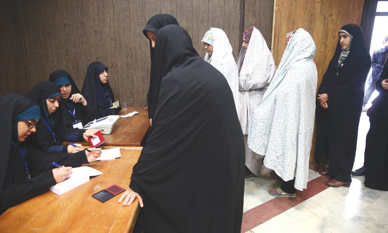 Women line up to cast their votes at a polling station in Tehran on Friday.—Reuters