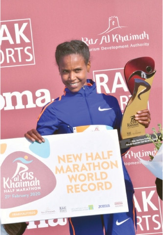 ABABEL Yeshaneh poses on the podium after winning RAK Half Marathon.—AFP