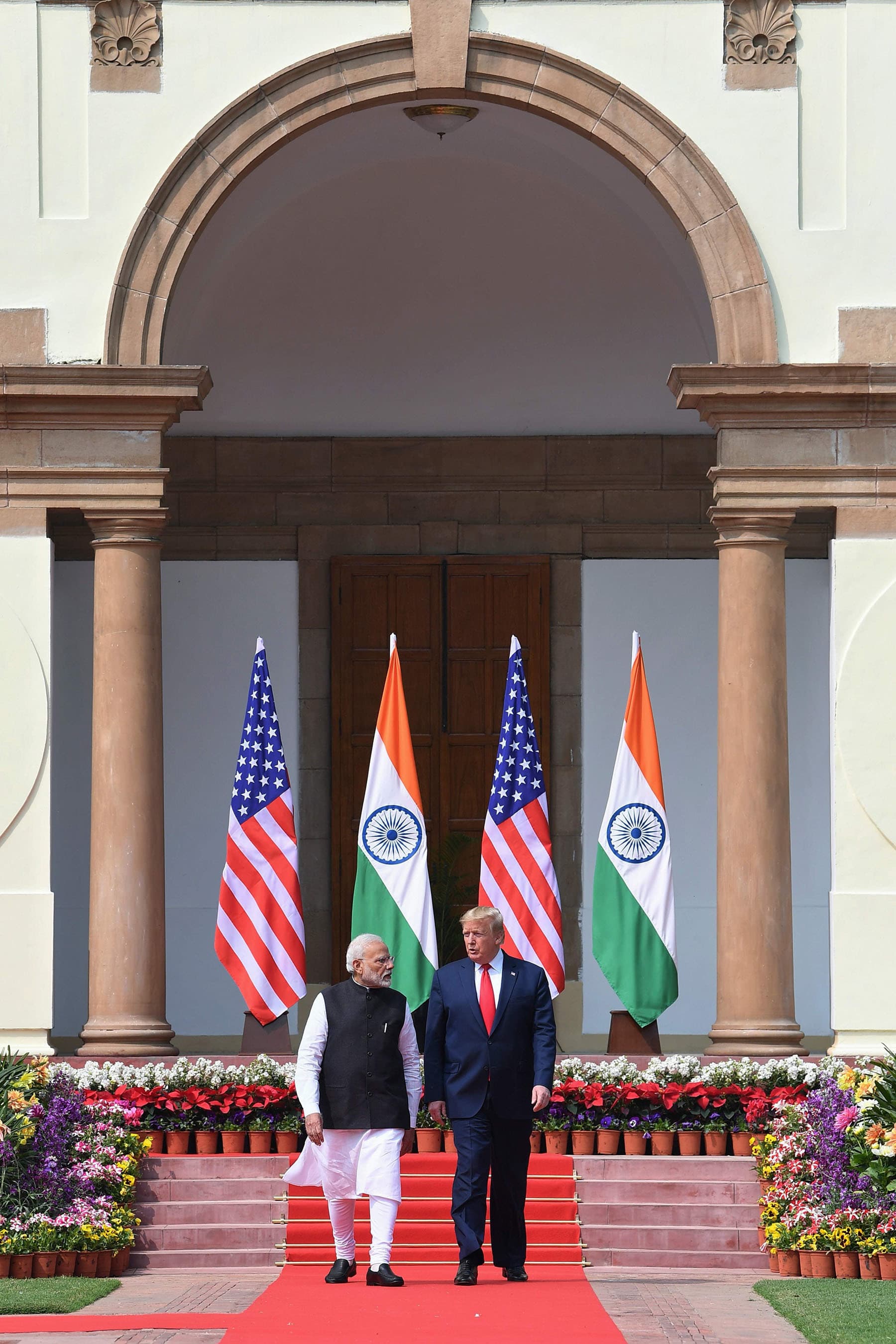 US President Donald Trump (R) and India's Prime Minister Narendra Modi arrive for a joint press conference at Hyderabad House in New Delhi.  — AFP PHOTO/MEA