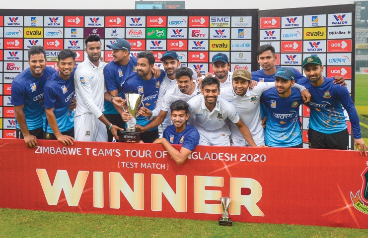 BANGLADESH cricketers pose with the trophy after winning the one-off Test against Zimbabwe at the Sher-e-Bangla National Stadium on Tuesday.&mdash;AFP