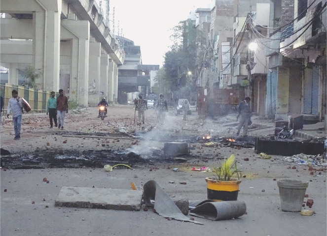 NEW DELHI: A vandalised street seen after violence between two groups on Tuesday.—AP