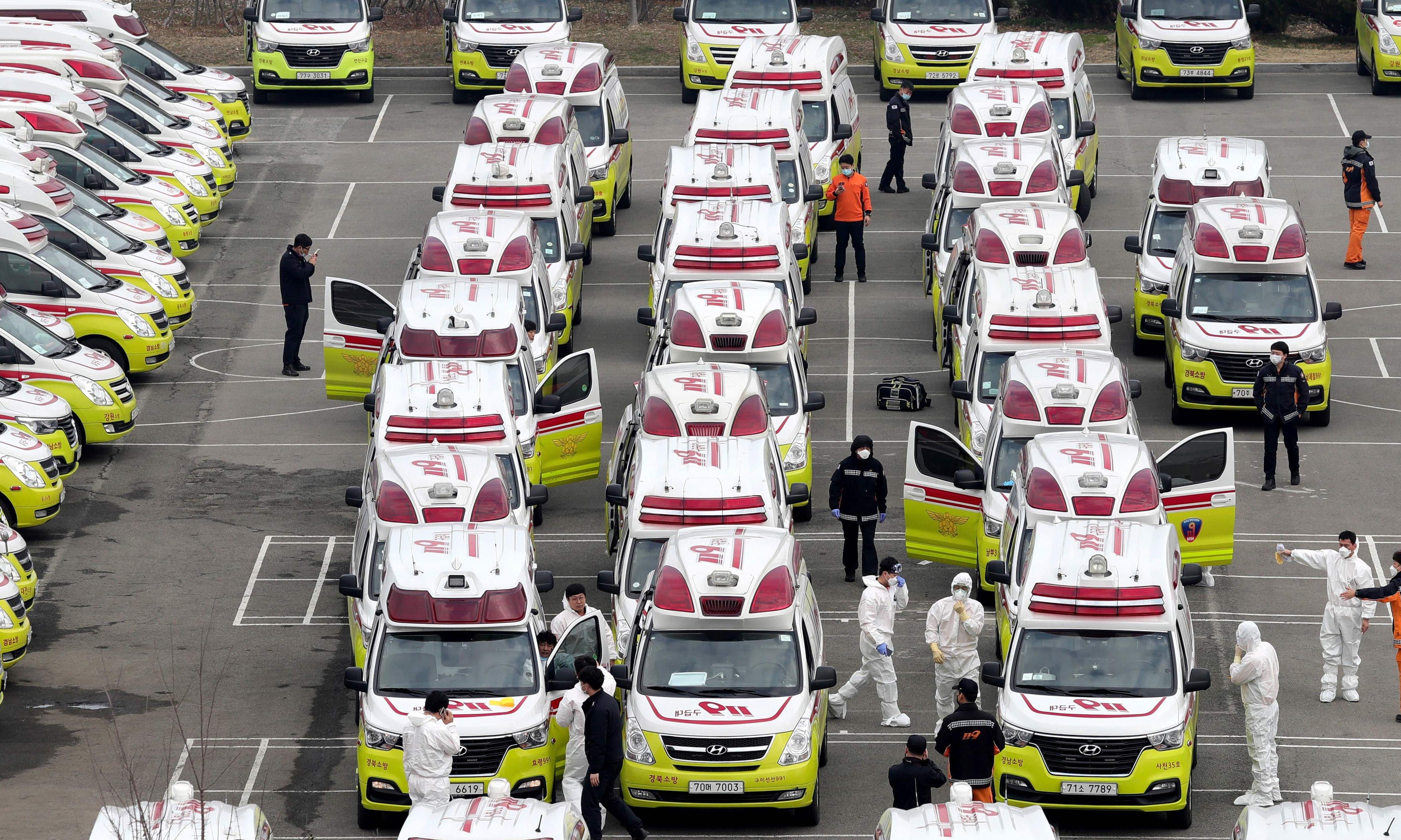 Paramedics wearing protective gear prepare ambulances to transport patients infected with the COVID-19 coronavirus in Daegu. South Korean President Moon Jae-in has said that the government is waging "all-out responses" to contain the novel coronavirus as the country reported 376 new cases, taking the total to 3,526. &mdash; AFP