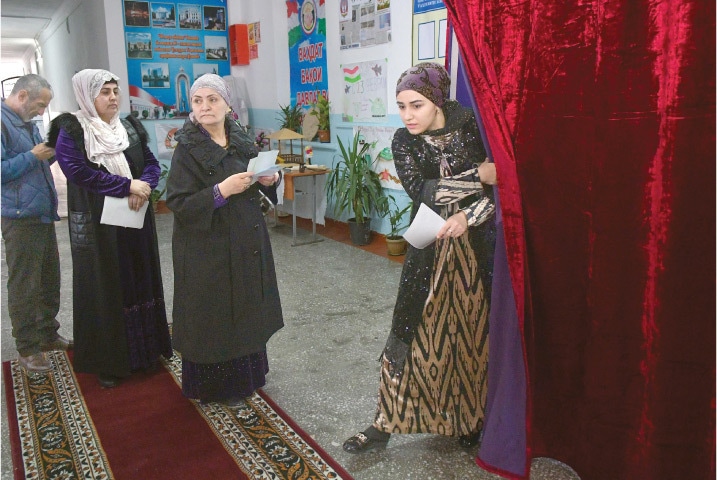 DUSHANBE: A woman leaves a voting booth after casting her ballot in Tajikistan&rsquo;s parliamentary election.&mdash;AFP