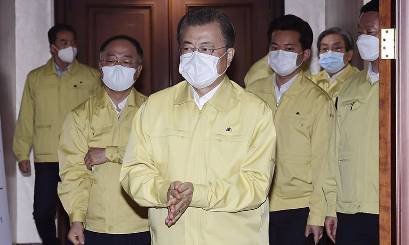 South Korean President Moon Jae-in, centre, wearing a face mask arrives to preside over a cabinet meeting at a government complex in downtown Seoul, South Korea on Tuesday. — Han Sang-kyun/Yonhap via AP