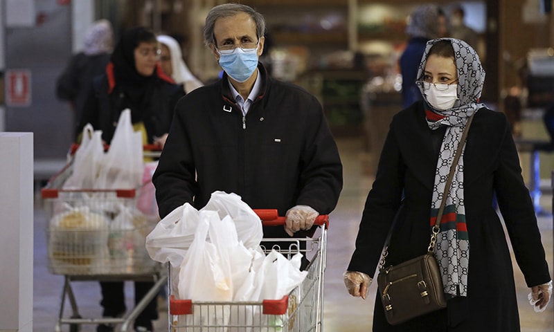 Shoppers wearing face masks and gloves shop at the Palladium Shopping Centre in northern Tehran, Iran, Tuesday. — AP