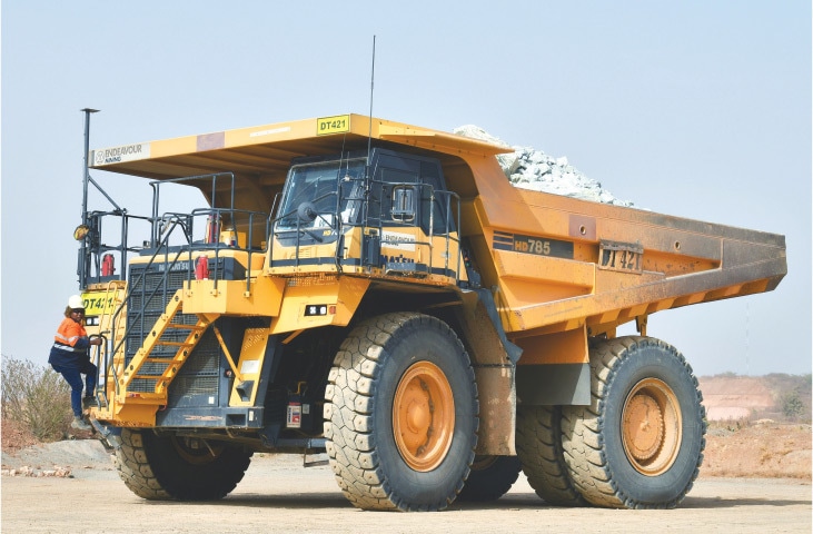 HOUNDE: Tene Konate, 42, climbs on her dumper truck at the gold mine site.—Reuters