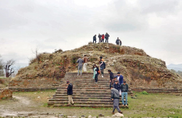 Youth delegates visit ancient Buddhist site in Lower Dir on Friday. &mdash; Dawn