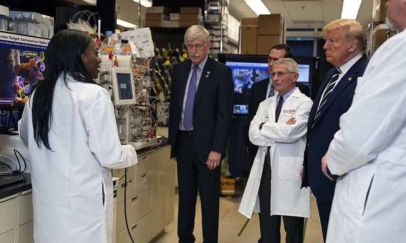 In this Tuesday, March 3, 2020 file photo, Dr Kizzmekia Corbett, left, senior research fellow and scientific lead for coronavirus vaccines and immunopathogenesis team in the Viral Pathogenesis Laboratory, talks with President Donald Trump as he tours the Viral Pathogenesis Laboratory at the National Institutes of Health in Bethesda, Maryland. &mdash; AP