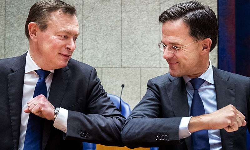 Dutch Prime Minister Mark Rutte (R) gives Dutch Minister for Medical Care Bruno Bruins an elbow greeting in order to prevent the spread of the novel coronavirus during the weekly Question Time in the Lower House in The Hague, The Netherlands on March 10, 2020. &mdash; AFP