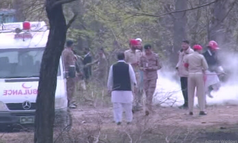 Security officials at the crash site. — DawnNewsTV