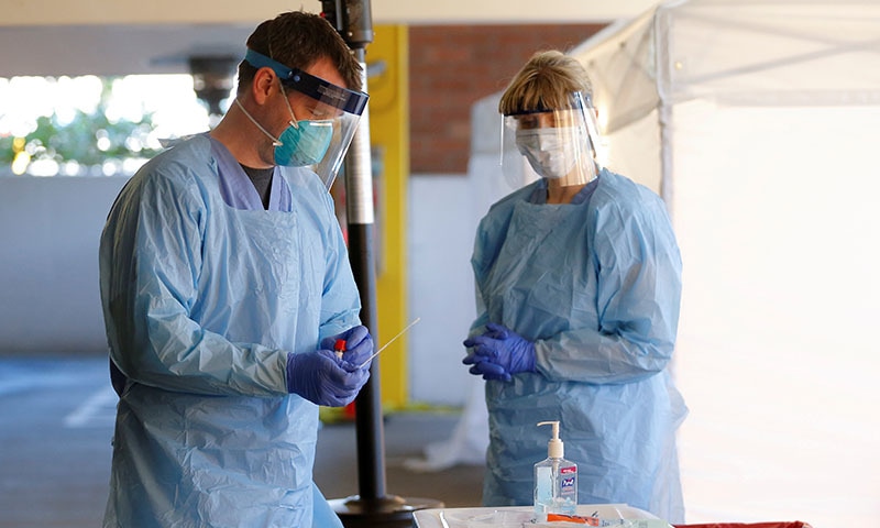 FILE PHOTO: Nurse Jeff Gates processes a patient sample at a drive-through testing clinic for coronavirus, flu and RSV, currently by appointment for employees at UW Medical Center Northwest in Seattle, Washington, U.S. March 9, 2020. REUTERS/Lindsey Wasson/File Photo