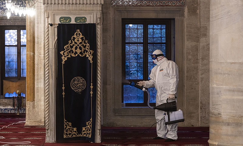 A worker wearing protective clothing disinfects a historical mosque, in Istanbul, Wednesday, March 11, 2020, as a precaution against the coronavirus. Turkey's Health Minister Fahrettin Koca announced the first case of coronavirus in Turkey on Wednesday. — AP