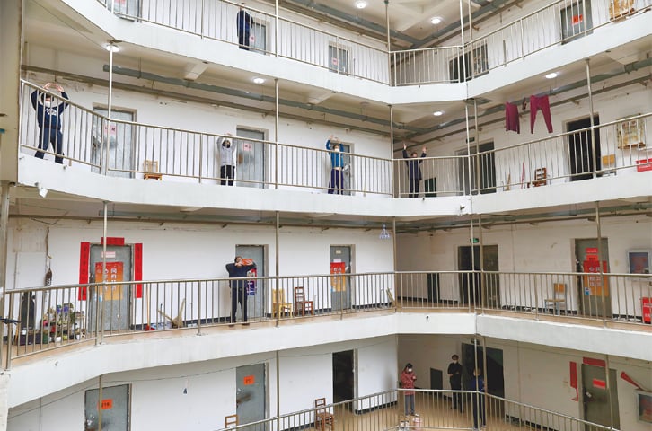 WUHAN: Patients cured of the virus and discharged from hospitals exercise at a quarantine centre on Thursday.—Reuters WUHAN: Patients cured of the virus and discharged from hospitals exercise at a quarantine centre on Thursday.—Reuters