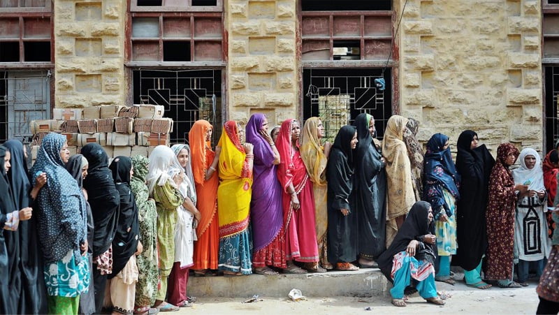 Women line up to receive money from the Benazir Income Support Programme in Karachi | Reuters