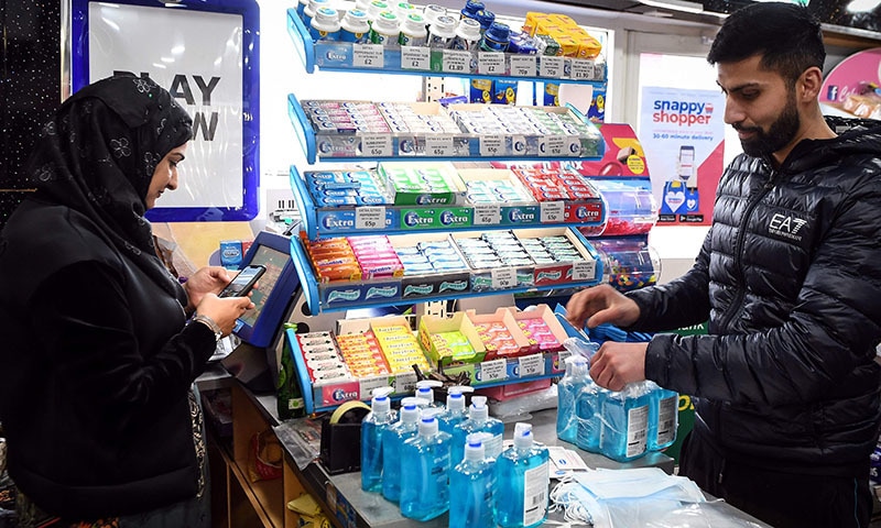 Jawad Javed and his wife Asiyah put together coronavirus protection kits to be delivered the vulnerable people of their community of Stenhousemuir, between Glasgow and Edinburgh in Central Scotland on March 16, 2020. (Photo by Andy Buchanan / Digital / AFP) &mdash; &copy; Andy Buchanan 2020 All Rights Reserved.1/2 212 Battlefield RoadGlasgowG42 9HN07939 215079andybuchanan@me.com