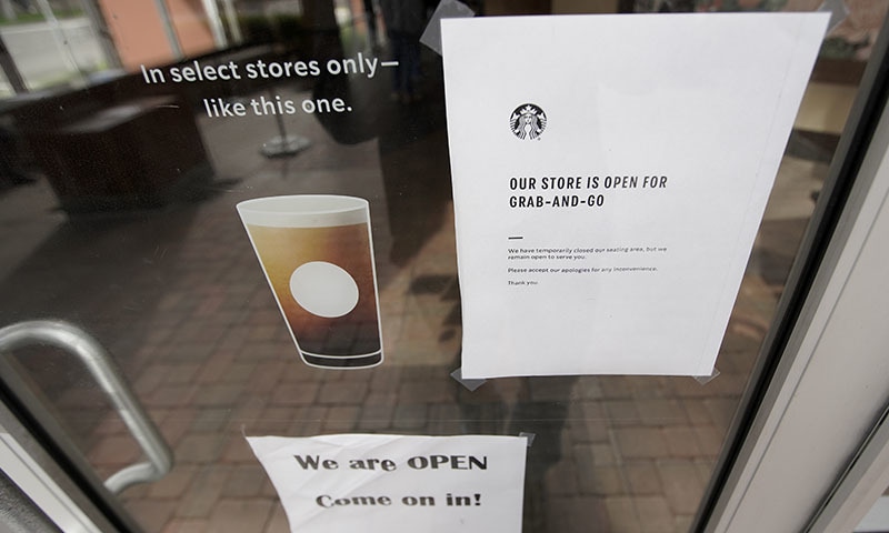 A sign informs customers that it is a open for take out only to help stop the transmission of COVID-19 coronavirus at a Starbucks, Monday, March 16, 2020, in Orange, Calif. According to the World  Health Organization, most people recover in about two to six weeks, depending on the severity of the illness. (AP Photo/Chris Carlson) &mdash; Copyright 2020 The Associated Press. All rights reserved