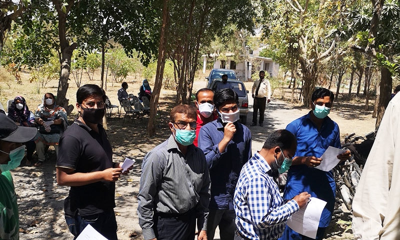 People standing outside the Dow Corona screening clinic in Karachi.