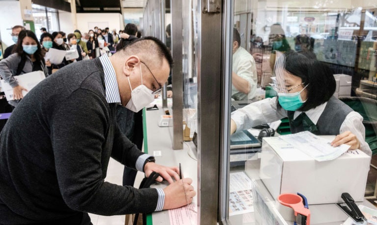 Hong Kongers like Adrian W. Chan are now sending parcels of face masks and other supplies to friends and relatives abroad as the virus spreads — AFP