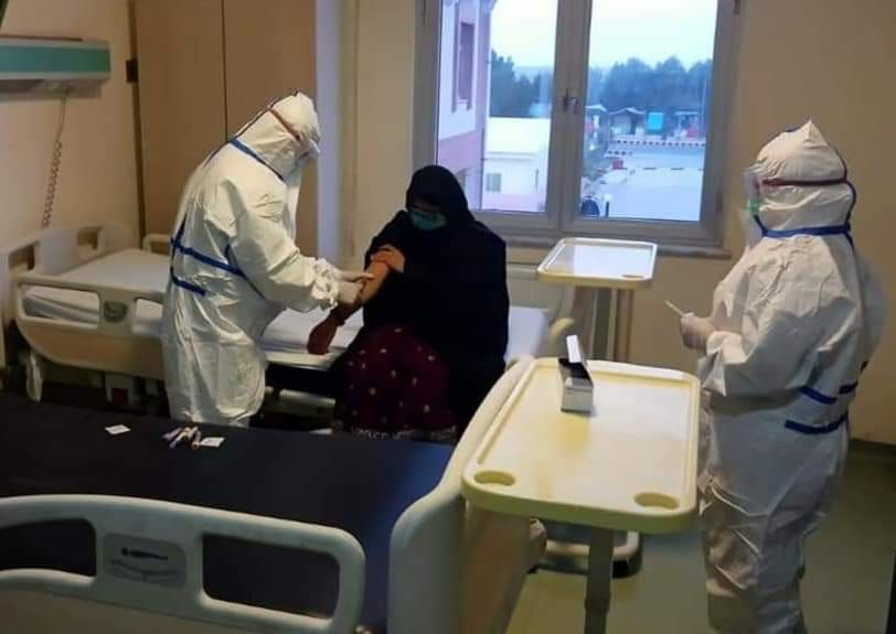 .Doctors in PPE carry out tests on a patient at a hospital in Muzaffargarh. — Photo courtesy: Government of Punjab