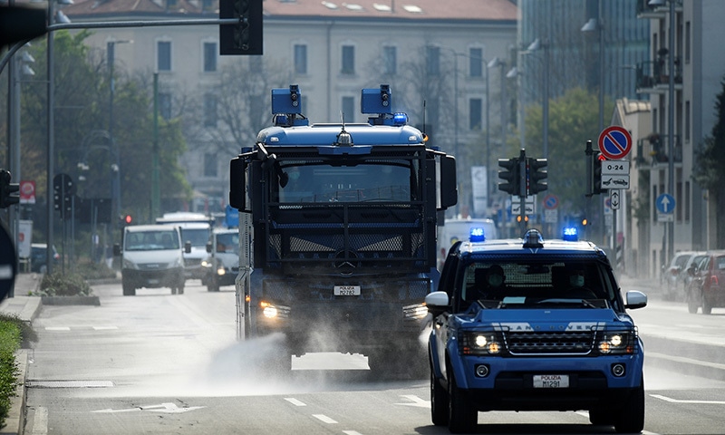 A vehicle of the Italian police sanitizes a street amid concerns about the spread of coronavirus disease (COVID-19) in Milan, Italy March 20, 2020. REUTERS/Daniele Mascolo