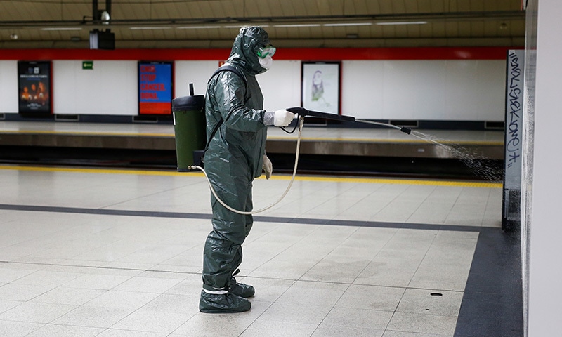 A Military Emergency Unit member disinfects Nuevos Ministerios metro station during a partial lockdown as part of a 15-day state of emergency to combat the spread of coronavirus disease in Madrid, Spain on March 20, 2020. &mdash; Reuters