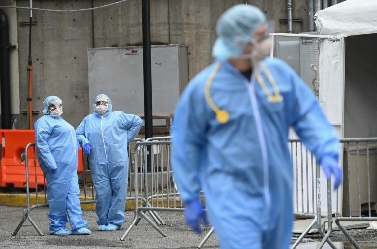 Medical staff stand outside a coronavirus screening tent in Brooklyn, New York — AFP