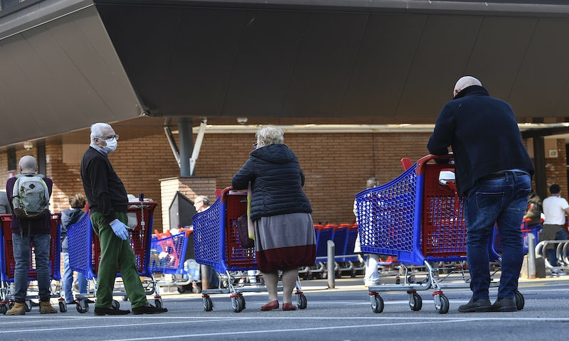 People queue at a Carrefour supermarket, waiting to enter on Saturday, March 21, 2020, in Turin, Italy. Italian Premier Giuseppe Conte has told the nation he is tightening the lockdown to fight the rampaging spread of the coronavirus, shutting down all production facilities except those that are “necessary, crucial, indispensable to guarantee essential goods” for the country. Conte said Italy is living through its gravest crisis since World War. — AP