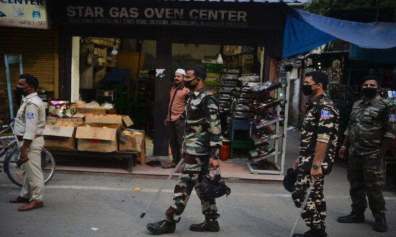 Police personnel ask shop owners to close their stores in a market area after authorities imposed a lockdown as a preventive measure against the novel coronavirus in Siliguri, India, on March 23, 2020. — AFP