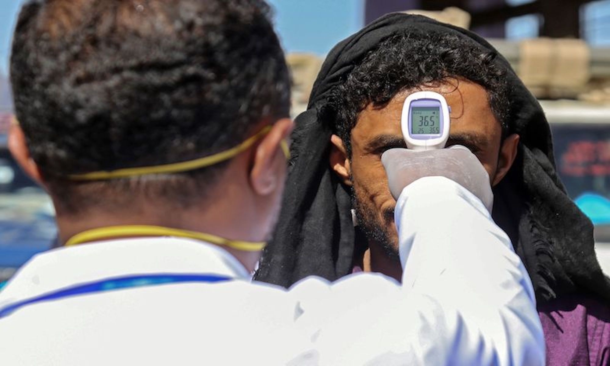 A health official checks the body temperature of man at the entrance of the city of Taez in southwestern Yemen on March 23, 2020 amid concerns over the spread of the COVID-19 novel coronavirus. (Photo by Ahmad AL-BASHA / AFP) &mdash; AFP or licensors