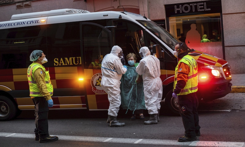 A patient, centre, is transferred to a medicalised hotel during the COVID-19 outbreak in Madrid, Spain. The coronavirus is winning a war of attrition waged against health care workers throughout the world but more so in Spain, where necessary equipment to shield them from contagion and enough testing kits for the new virus have been lacking for weeks. —AP