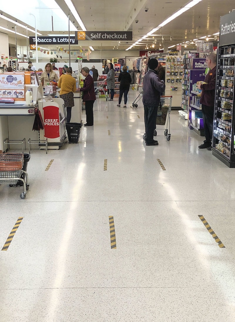 Markings on the floor to implement social distancing measures at the checkout of a Sainsbury's store after Britain's Prime Minister Boris Johnson has put the UK in lockdown to help curb the spread of the coronavirus, in Petersborough, England on Thursday March 26, 2020. &mdash; AP