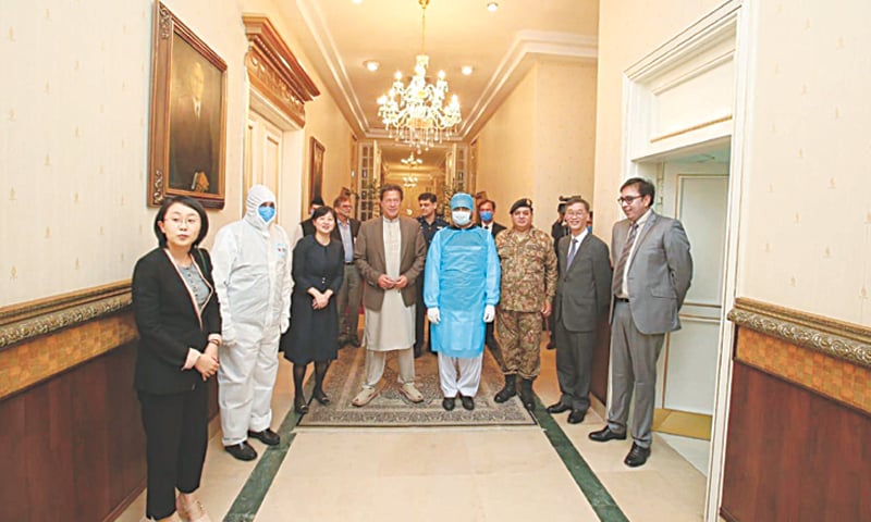 ISLAMABAD: Prime Minister Imran Khan pictured with Chinese Ambassador to Pakistan Yao Jing and members of his delegation at PM Office on Thursday. The ambassador said assisting Pakistan in its fight against Covid-19 is one of Beijing’s priorities. China’s assistance includes 12,000 testing kits, 300,000 masks, 10,000 protective suits and $4m for building a hospital. The Xinjiang government has, meanwhile, provided 50,000 masks each to Islamabad Capital Territory as well as the Sindh government.