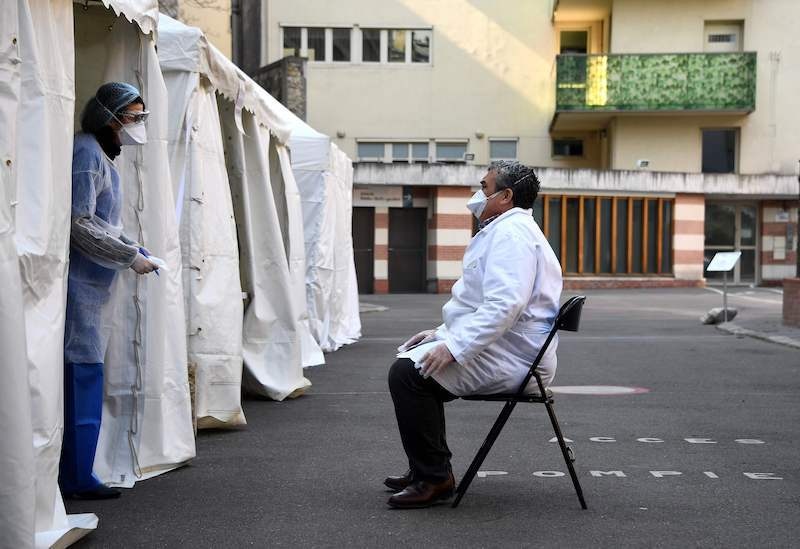 A pharmacist has samples taken at a Covid-19 screening centre reserved for health professionals on March 27, 2020 in Paris, as the country is under lockdown to stop the spread of the pandemic caused by the novel coronavirus. &mdash; AFP