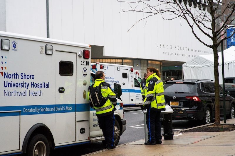 Paramedics wait for a call next to a makeshift morgue set outside Lenox Health Medical Pavilion as the coronavirus disease outbreak continues in New York, US, on March 29, 2020. &mdash; Reuters