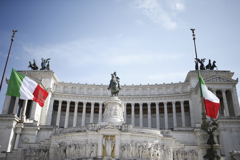 Flags fly at half-staff during a minute of silence commemorating the Covid-19 virus victims, at Rome's monument to the Unknown Soldier on Tuesday, March 31, 2020. Italy has observed a minute of silence and flown its flags at half-staff in a nationwide gesture to honour the victims of the coronavirus and their families. — AP