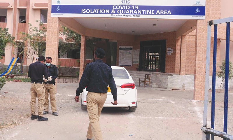 POLICE stand guard inside the Kohsar Hospital in Latifabad on Tuesday as local residents protest outside over converting it to a quarantine centre.&mdash;PPI