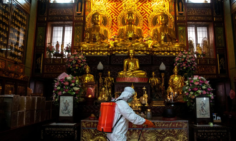 A volunteer wearing a protective gear sprays disinfectant while sanitising at Wat Dibaya Varivihara due to the spread of Covid-19 in Bangkok, Thailand, April 2. &mdash; Reuters