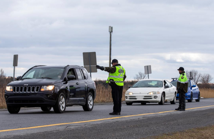 Surete du Quebec police officers set up a checkpoint for drivers approaching the province from neighbouring Ontario to enforce Covid-19 restrictions near Saint-Zotique, Quebec, Canada April 1. — Reuters