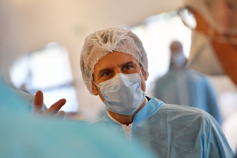 French President Emmanuel Macron wearing protective suit and face mask visits the Kolmi-Hopen protective face masks factory in Saint-Barthelemy-d'Anjou near Angers, central France, on March 31, 2020 amid a new coronavirus pandemic. — AFP
