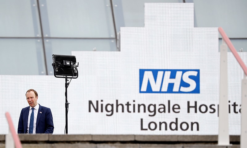 Britain's Health Secretary Matt Hancock speaks during a television interview at the opening of the "NHS Nightingale" field hospital, created at the ExCeL London exhibition centre, in London on April 3. — AFP